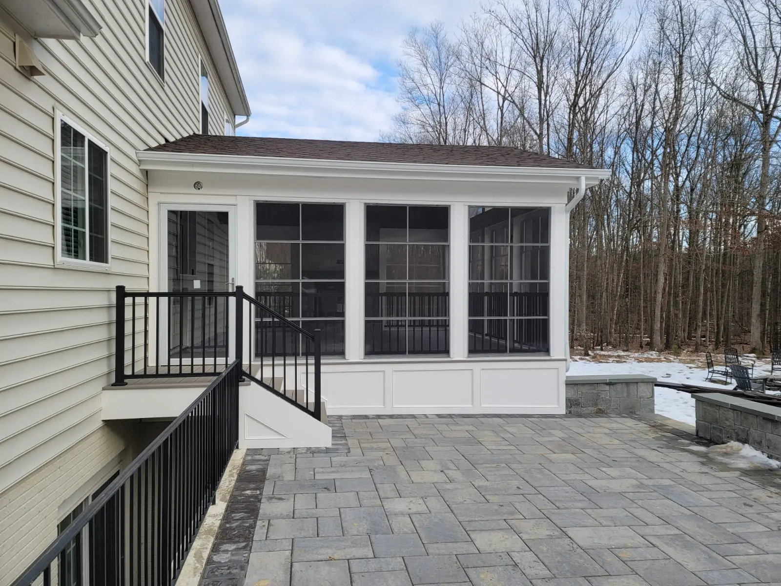 BILDEN screened porch with large panels, exterior stairs, black railing and paver patio